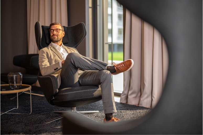 Mann sitzt in einem Sessel